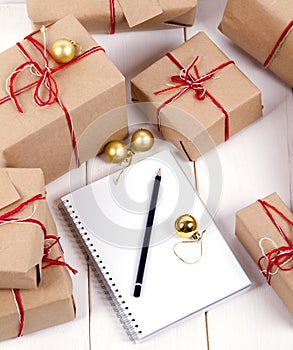 Wish list in to notebook near christmas gifts