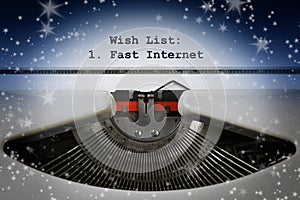 Wish list, written on an old typewriter with a single item, Fast Internet. Some stars in the dark background, Christmas concept