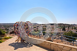 The wish tree is all in multicolored ribbons, standing on a platform near the Church of St. Elijah in Protaras. Cyprus