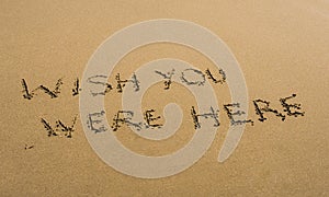 Wish You Were Here written in sand