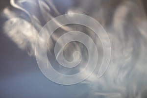 wisps of smoke on a dark background