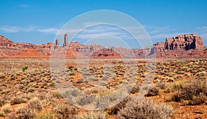 Wispy clouds rise above the pinnacles and red rock monuments at the Valley of the Gods in Utah