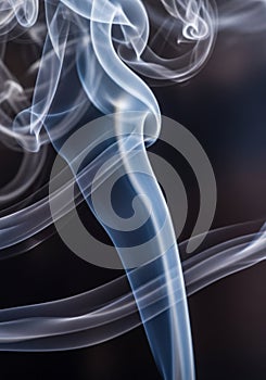 Wispy trails of smoke against a dark background create an abstract pattern. The