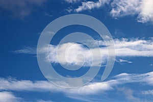 Wispy white clouds in blue sky