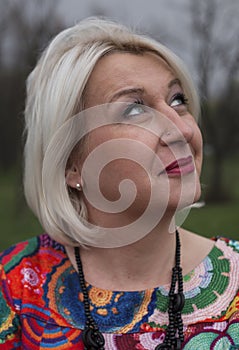 Wistful middle aged woman looking into the distance