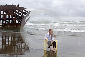 Wistful Woman On Beach With Shipwreck