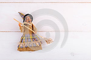 The witch Befana on white wooden background, top view, copy space