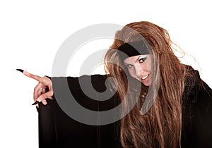 Witch in black costume and long hair point