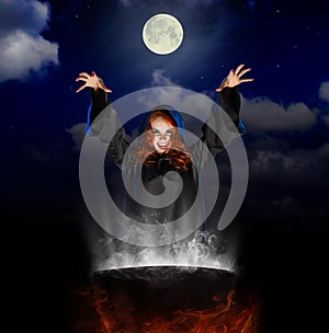 Witch with cauldron on night sky background