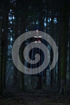 A witch celebrating the spells from the book