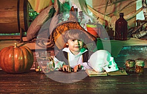 Witch children with trick or treat. Surprised boy in Halloween costume holding orange pumpkin. Halloween kids.