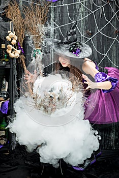 Witch conjures and cooks a love potion photo