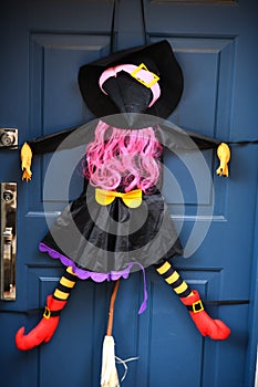 Witch on the door as Halloween decoration.
