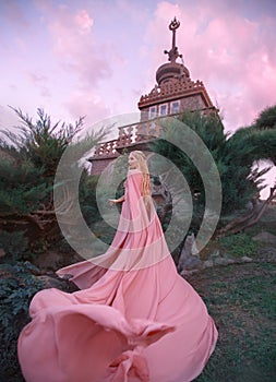 Witch elf rises to the castle, princess with blond hair, oblique and tiara dresses pink dress and cloak with a long
