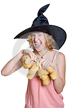 Witch girl in a haloween black hat with teddy bear