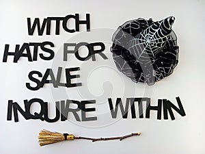 Witch hats for sale inquire within Halloween sign on a white background