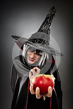 Witch offering a poisoned apple photo