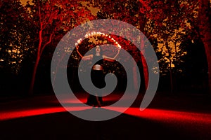 Witch in the dark forest playing with lights