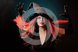Witch practises witchcraft on black background.