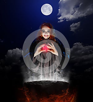 Witch with red potion and cauldron on night sky background