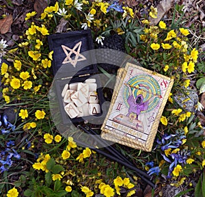 Witch runes, black candles and tarot cards