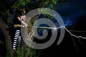 Witch strikes lightning from the broomstick