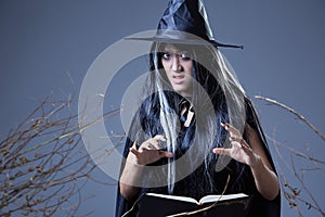 Witch using spell book