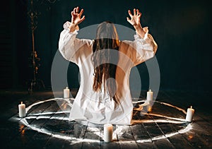 Witch produces occult ritual in pentagram circle