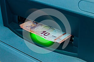 Withdraw money from ATM. 10 Euro banknotes at ATM machine
