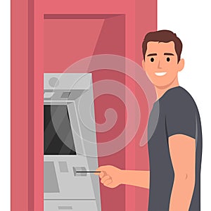Withdrawing money on atm concept. Young man standing entering pincode on atm machine for getting money cash