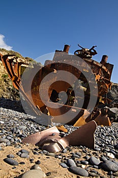 Withered and half buried propeller of a wrecked pusher boat photo