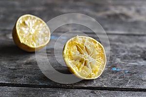 Withered Half Lemon on old wooden table