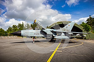 WITTMUND, GERMANY- JUNE 29, 2013: German Air Force Panavia Tornado IDS fighter bomber jet in front of a hardened shelter on photo