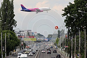 Wizz Air approaching the airport, flying over the road