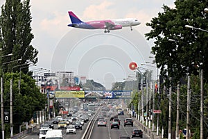 Wizz Air approaching the airport, flying over the road