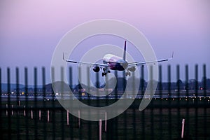 Wizz Air plane in the sky, landing on runway