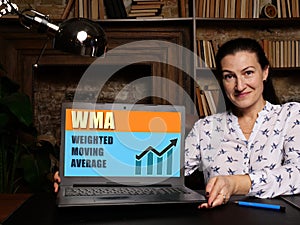 WMA WEIGHTED MOVING AVERAGE. Business and finance concept on device screen photo