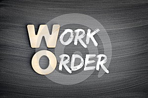 WO - Work Order acronym, business concept on blackboard