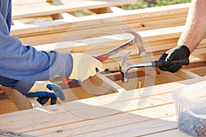 Wod carpentry. Worker hammering nail