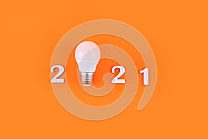 Wodden 2021 Creativity and inspiration ideas concepts with lightbulb on pastel color background.Business solution. Christmas