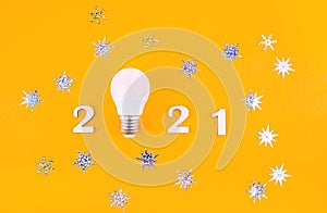 Wodden 2021 Creativity and inspiration ideas concepts with lightbulb on pastel color background.Business solution. Christmas