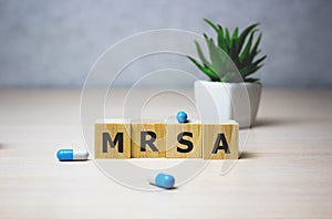 Wodden cubes with words MRSA Methicillin-resistant Staphylococcus Aureus. Medical concept photo