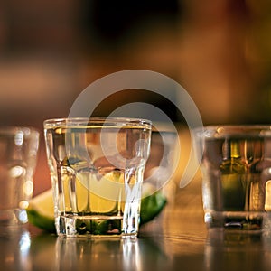 Wodka shots on wooden table closeup