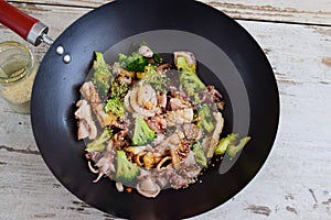 Wok fried squid with broccoli, soy sauce and sesami seeds.