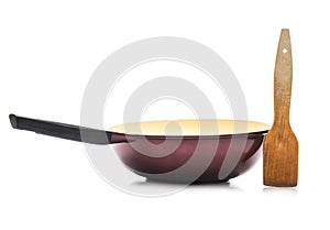 Wok with wooden spatula isolated on white background