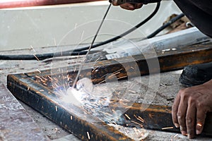 Woker welding steel with sparks lighting