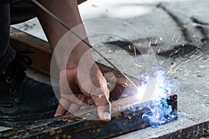 Woker welding steel with sparks lighting