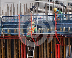 Woker are woking on top of concrete structure pole with seafty set