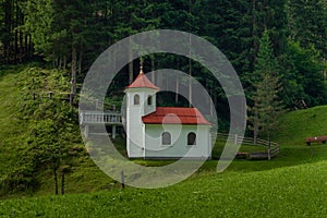 Wolfaukapelle chapel in sunny cloudy morning in Austria mountains