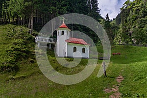 Wolfaukapelle chapel in sunny cloudy morning in Austria mountains